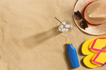 Top view straw hat with copy space. Traveler accessories on sand. Travel vacation concept. Summer background