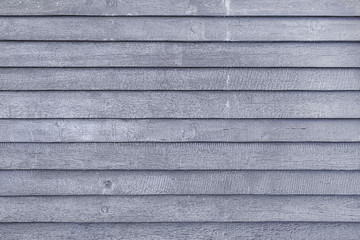 Toned photo of a fence made of wooden boards. Dark gray background for layouts and sites.