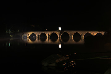 Fototapeta na wymiar Mehmed Pasa Sokolovic Bridge by night, historic bridge in Visegrad, over the Drina River in eastern Bosnia and Herzegovina