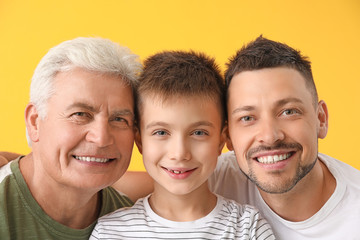 Man with his father and son on color background