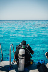 Scuba diver before diving. A diving lesson in open water.