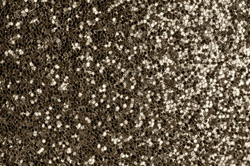 Bright photo of gold sparkles close-up. Festive background for sites and layouts.