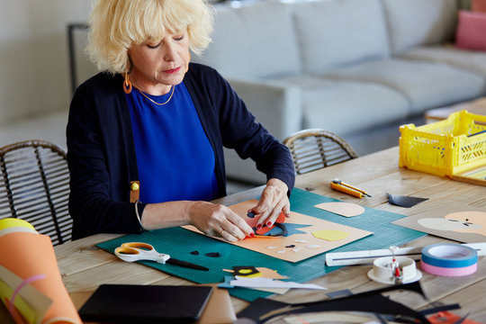 Senior woman making a collage