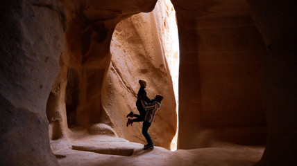Travel couple standing into the cave surrounded by rock formations at Zelve Valley in Cappadocia, Turkey © Seckin Ozturk