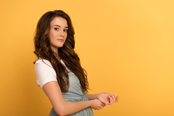 Obraz premium beautiful young spring woman with long hair on yellow