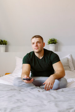 Man watching TV on bed