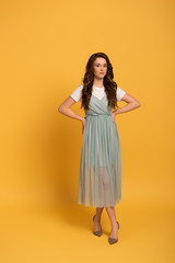 beautiful girl in t-shirt and dress on yellow