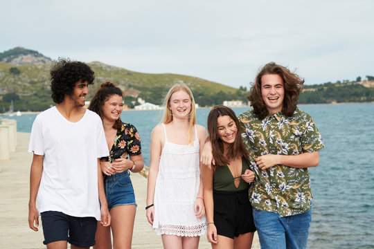 Chilling cool friends strolling on seafront