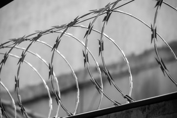 Barbed wire fence over a wall protecting a private property