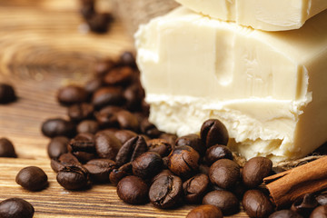 Composition with grains of coffee, soap on the wooden table, close up