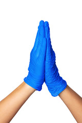 Hands in latex medical gloves folded together indicating the process of prayer. Close up.