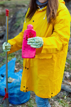A man and a woman clean the reservoir of plastic and garbage.