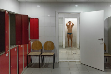 Man taking shower after swimming in pool