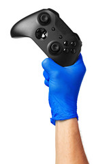Video game console controller in gamer gloved hands. Games during isolation at home, coronavirus