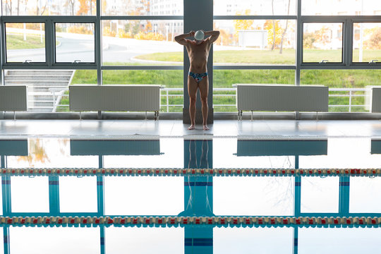 Sportsman on poolside before swimming