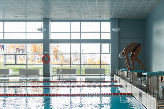 Sportive man before jumping in pool
