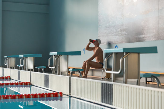 Swimmer drinking water in pool