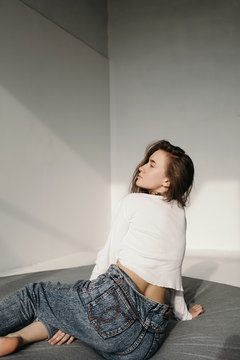 Young woman enjoying sunlight on bed