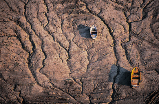 Wooden boat on dry lake
