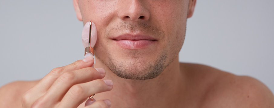 Closeup man using stone roller