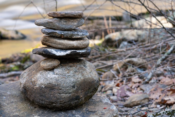 Rock Cairn on the side of the rushing river