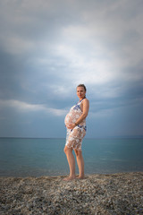Adorable Pregnant woman on the beach