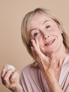Mature woman hydrating skin