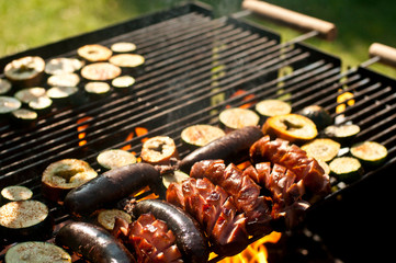 Vegetables and sausage on grill