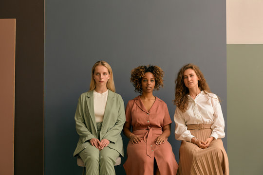 Three Attractive Young Women Sitting