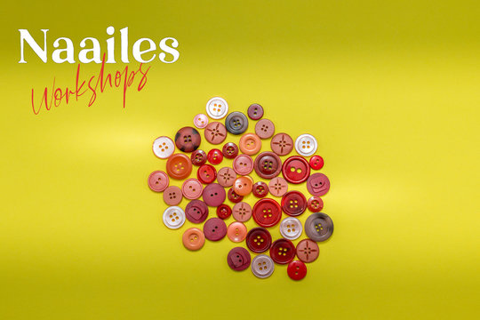 Naailes, Dutch word for sewing lessons on a yellow background with a pile of red sewing buttons. Room for copy. 