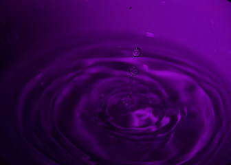 Naklejka na ściany i meble Drop of water on white bowl, violet tones