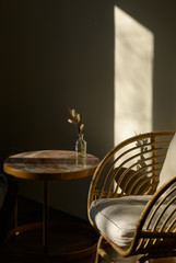 Fototapeta na wymiar a table and chair made of bamboo in the sunshine cozy homely atmosphere
