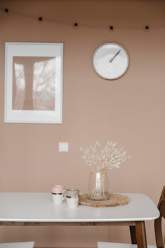 Cups and flowers on dining table