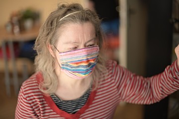 Down syndrome woman with respirator mask