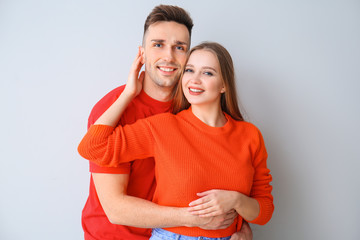 Happy young couple on light background