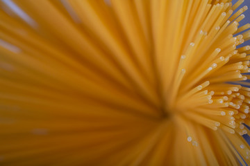 Selective paste focus. Concept of cooking and Italian cuisine. Spaghetti is a long-term storage product during the coronavirus pandemic. Copy space. Horizontal orientation. Raw spaghetti