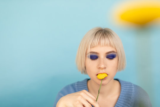 Model with dandelions on light blue background