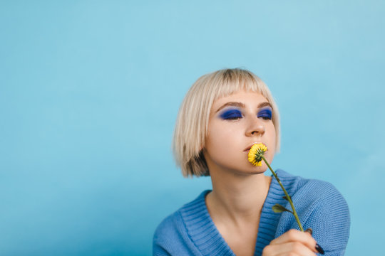 Model with dandelions on light blue background
