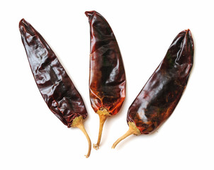 three dried spicy peppers