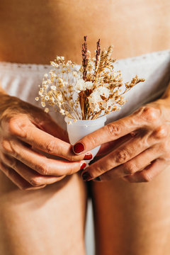 Girl holding a menstrual cup.