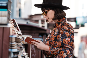 Stylish Woman Looking At The Books On The Street Market