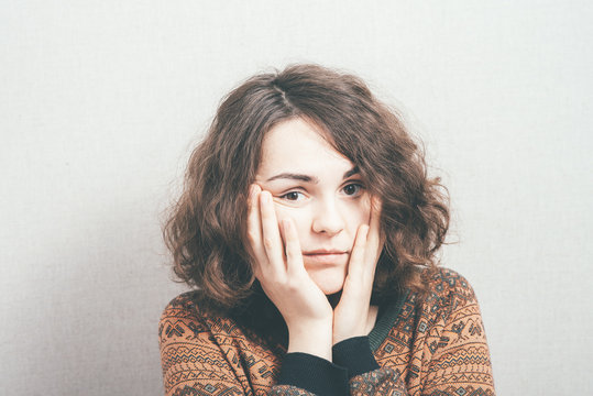 woman, put her hands to the face