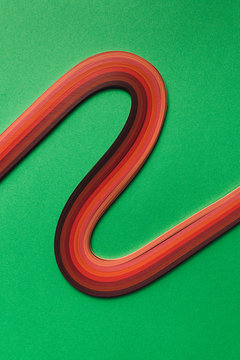 Multi colored quilling paper lying on colorful paper