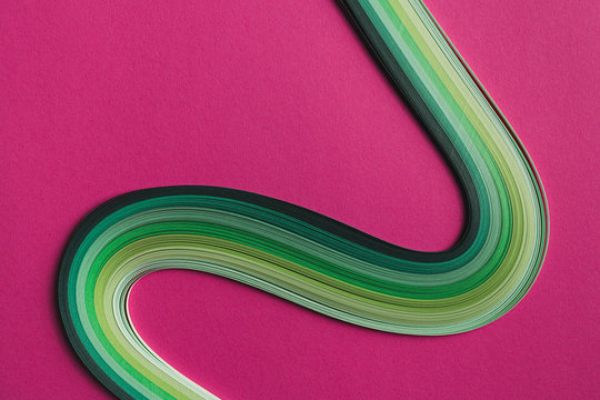 Multi colored quilling paper lying on colorful paper