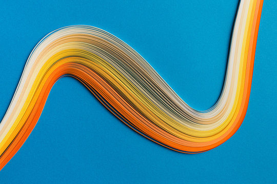 Multi colored quilling paper lying on colorful paper