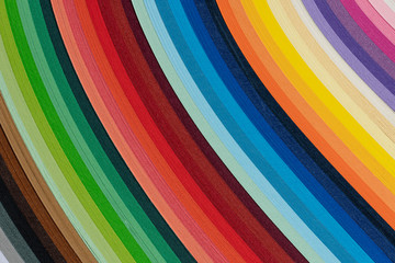 Multi colored quilling paper lying on colorful paper