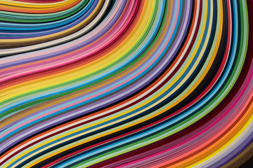 Multi colored quilling paper lying on colorful paper