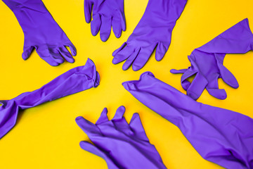 bunch of purple gloves thrown on yellow background, pattern