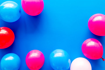 Decorative frame with colorful balloons on blue background top-down frame copy space