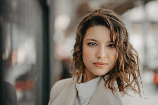 Beautiful young brunette girl close portrait looking in camera